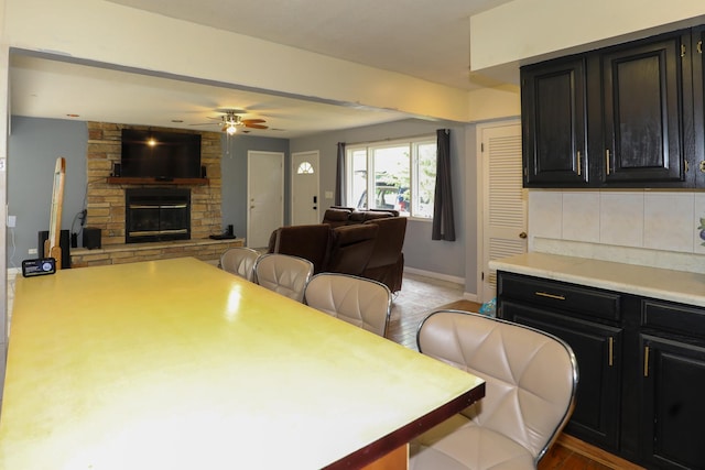19421 W Hoag Ct, Mundelein, IL 60060 - dining room featuring a ceiling fan, a fireplace, and baseboards