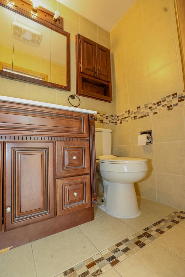 19421 W Hoag Ct, Mundelein, IL 60060 - half bath with tile patterned floors, toilet, tile walls, and vanity