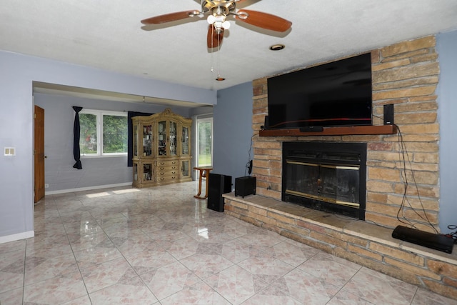 19421 W Hoag Ct, Mundelein, IL 60060 - unfurnished living room with a fireplace, a ceiling fan, and baseboards