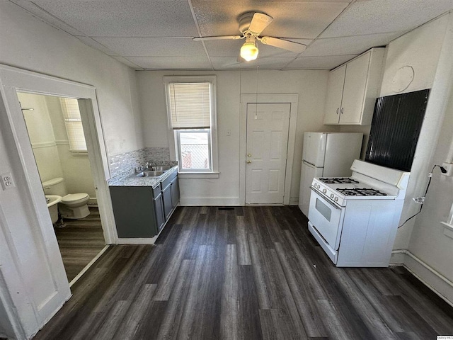 818-20 S 8th St, Quincy, IL 62301 - kitchen featuring white range with gas stovetop, a drop ceiling, light countertops, dark wood-style flooring, and a ceiling fan
