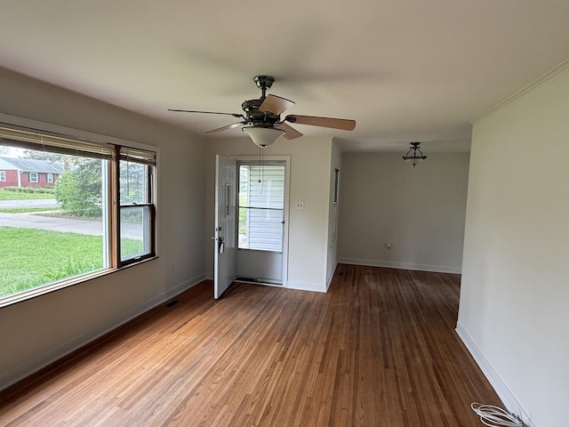 1310 S Sumner St, Wheaton, IL 60187 - spare room featuring wood finished floors, baseboards, and ceiling fan
