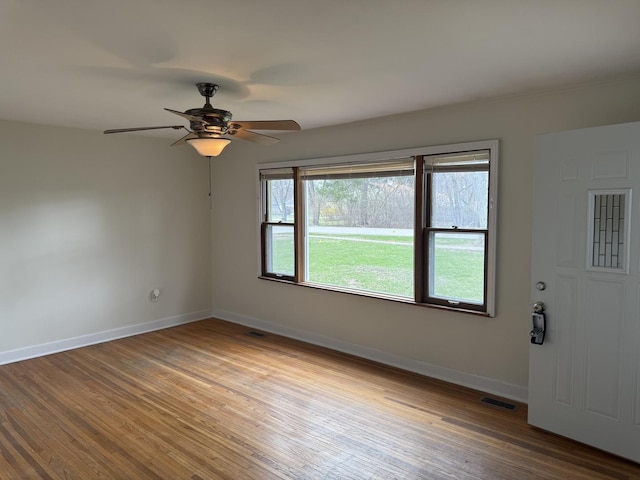 1310 S Sumner St, Wheaton, IL 60187 - spare room featuring baseboards, wood finished floors, and ceiling fan