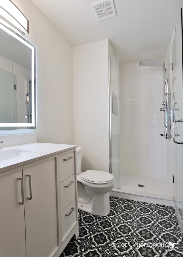620 Mallard Ct Unit C1, Bartlett, IL 60103 - bathroom with toilet, vanity, a shower stall, and tile patterned floors