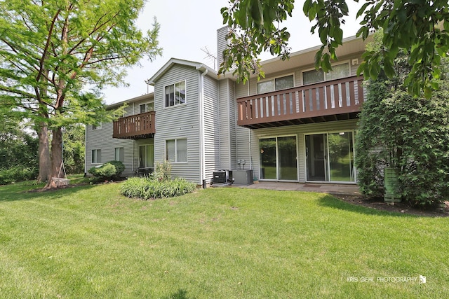 620 Mallard Ct Unit C1, Bartlett, IL 60103 - rear view of property featuring a chimney, central air condition unit, a yard, and a balcony