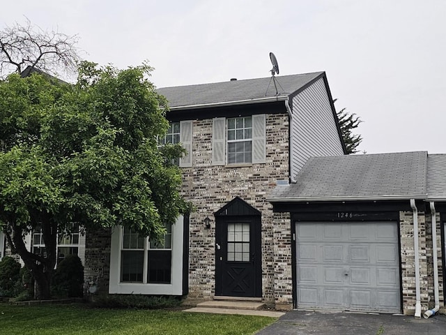 1246 Robin Dr, Carol Stream, IL 60188 - view of front of home with an attached garage, driveway, and a front lawn