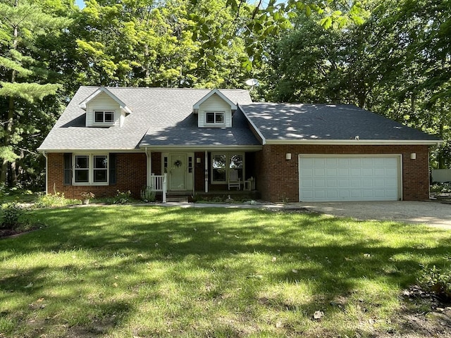 26136 E 2200 N Rd, Lexington, IL 61753 - cape cod home with an attached garage, brick siding, driveway, and a front lawn