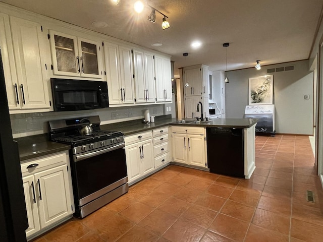 26136 E 2200 N Rd, Lexington, IL 61753 - kitchen with black appliances, a peninsula, dark countertops, tile patterned floors, and glass insert cabinets