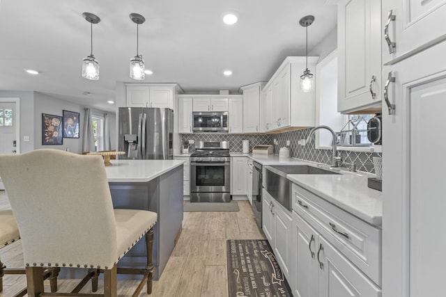 221 N 6th St, Saint Charles, IL 60174 - kitchen with stainless steel appliances, white cabinets, a kitchen bar, backsplash, and recessed lighting