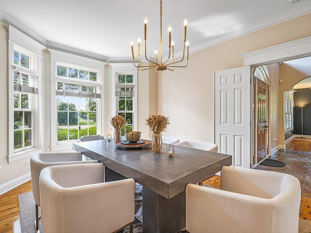 2207 N Elmkirk Pkwy, Mchenry, IL 60051 - dining area featuring baseboards, a chandelier, ornamental molding, and arched walkways