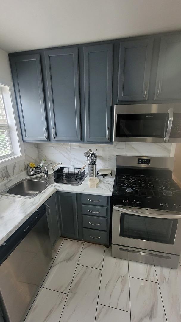 2676 N Julian Ter, River Grove, IL 60171 - kitchen with stainless steel appliances, a sink, light marble finish flooring, and gray cabinets