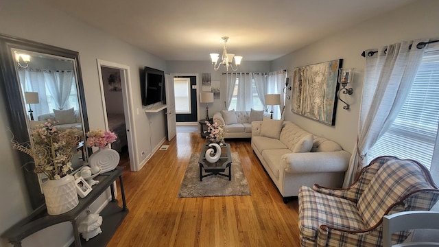 2676 N Julian Ter, River Grove, IL 60171 - living room featuring a chandelier, wood finished floors, and baseboards