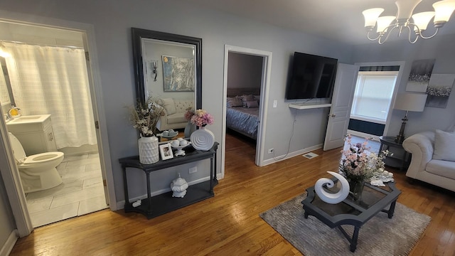 2676 N Julian Ter, River Grove, IL 60171 - living area with a chandelier, wood finished floors, and baseboards