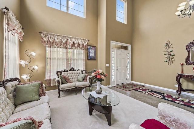 2023 Torino Dr, Elgin, IL 60123 - carpeted living room featuring a towering ceiling, baseboards, and a chandelier