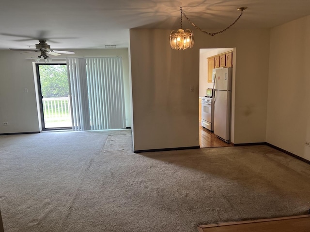 18040 Royal Oak Ct Unit 2, Tinley Park, IL 60477 - spare room with light carpet, ceiling fan, baseboards, and a chandelier