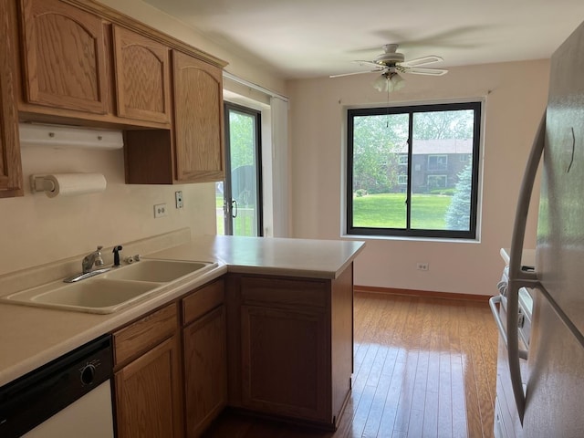 18040 Royal Oak Ct Unit 2, Tinley Park, IL 60477 - kitchen with dishwasher, a sink, plenty of natural light, and a peninsula