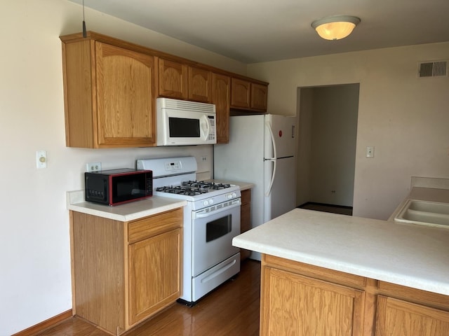 18040 Royal Oak Ct Unit 2, Tinley Park, IL 60477 - kitchen featuring white appliances, dark wood finished floors, light countertops, and a sink