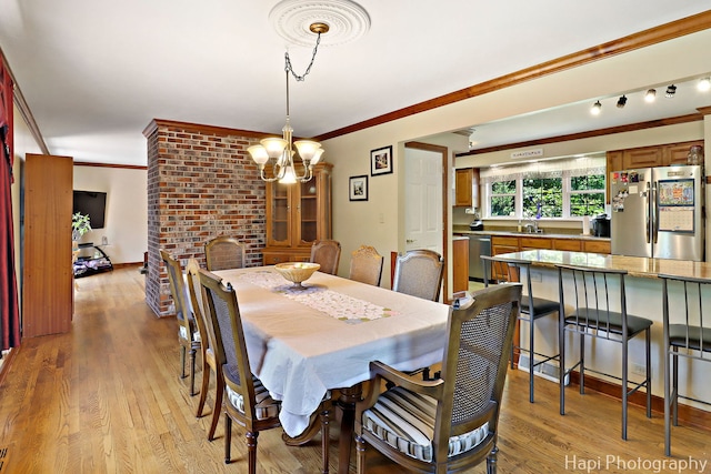 1415 Arabian Spur, Mchenry, IL 60051 - dining area featuring ornamental molding, light wood finished floors, and a chandelier
