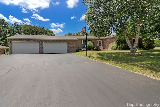 1415 Arabian Spur, Mchenry, IL 60051 - single story home with asphalt driveway, a garage, brick siding, and a front yard
