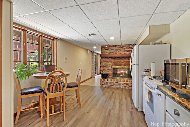 1415 Arabian Spur, Mchenry, IL 60051 - kitchen featuring white range oven, a brick fireplace, a drop ceiling, light wood-style floors, and stainless steel microwave