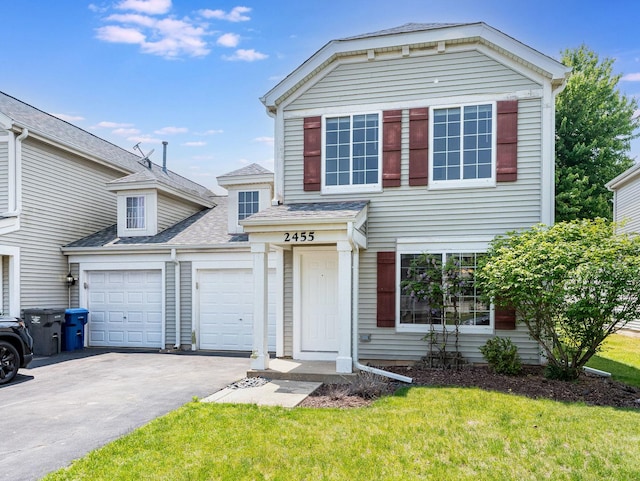2455 Hillsboro Ln, Montgomery, IL 60538 - traditional-style home with asphalt driveway, a shingled roof, a front lawn, and a garage