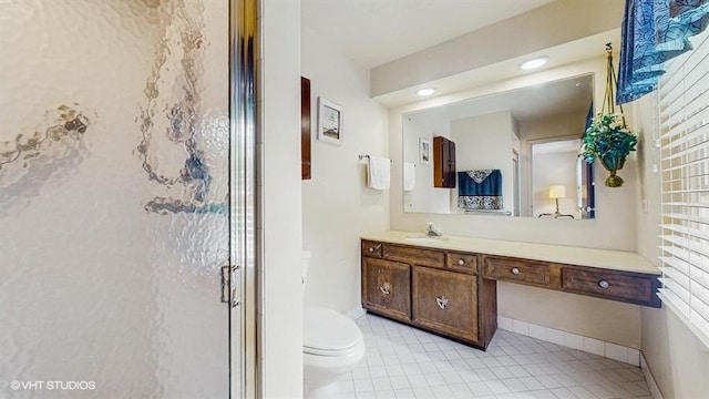 416 S Royal Ct, Palatine, IL 60067 - bathroom featuring vanity, toilet, tile patterned flooring, a stall shower, and baseboards