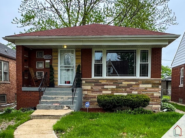 12211 S Lafayette Ave, Chicago, IL 60628 - view of front facade featuring a porch, brick siding, and stone siding