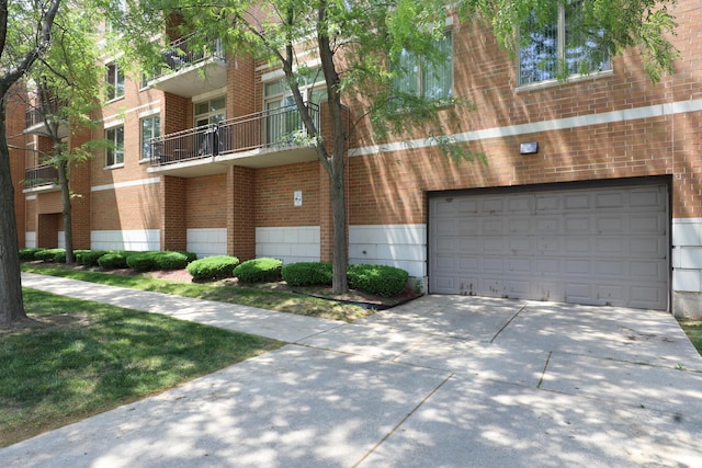 4330 N Neva Ave Unit 411, Norridge, IL 60706 - view of building exterior featuring a garage and driveway