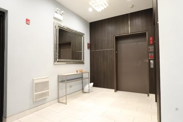 4330 N Neva Ave Unit 411, Norridge, IL 60706 - corridor featuring heating unit, elevator, a chandelier, and recessed lighting