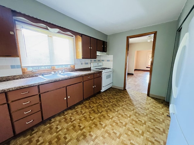 506 Scribner St, Joliet, IL 60432 - kitchen featuring white appliances, a sink, decorative backsplash, light floors, and under cabinet range hood