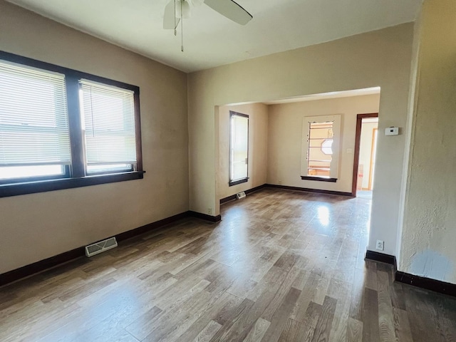 506 Scribner St, Joliet, IL 60432 - empty room with wood finished floors, ceiling fan, and baseboards