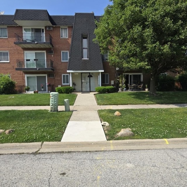 12850 Crestbrook Ct Unit 3, Crestwood, IL 60418 - view of front of home with mansard roof, brick siding, a front lawn, and roof with shingles