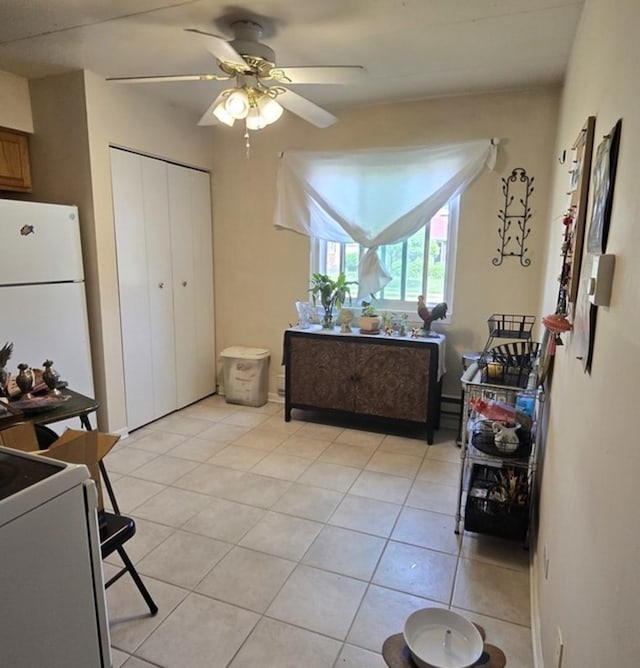 12850 Crestbrook Ct Unit 3, Crestwood, IL 60418 - kitchen featuring freestanding refrigerator, stove, ceiling fan, light tile patterned flooring, and brown cabinetry