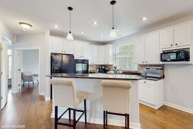 3432 Redwing Dr, Naperville, IL 60564 - kitchen featuring black appliances, dark countertops, white cabinets, backsplash, and recessed lighting