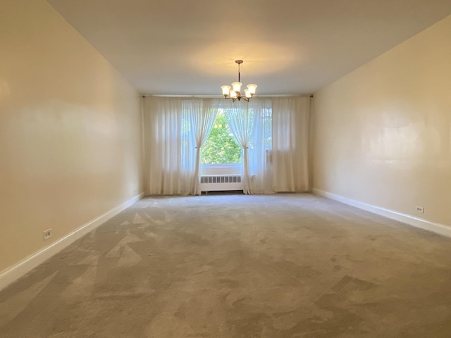 2834 W Granville Ave Unit 2A, Chicago, IL 60659 - carpeted empty room featuring radiator, a chandelier, and baseboards
