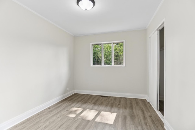 463 Tahoe St, Park Forest, IL 60466 - unfurnished bedroom featuring crown molding, wood finished floors, and a closet
