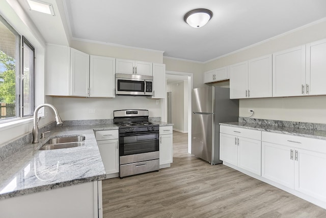 463 Tahoe St, Park Forest, IL 60466 - kitchen with stainless steel appliances, white cabinetry, crown molding, light stone counters, and light wood-style flooring