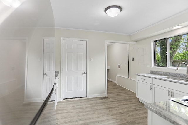 463 Tahoe St, Park Forest, IL 60466 - kitchen featuring crown molding, white cabinetry, light stone counters, and light wood finished floors