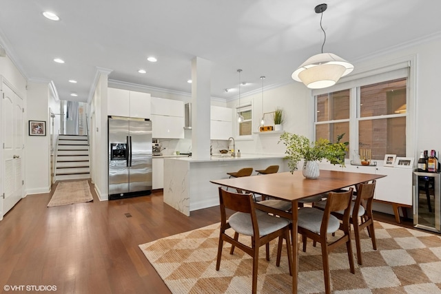 3020 N Sheffield Ave Unit 1N, Chicago, IL 60657 - dining area with wine cooler, crown molding, dark wood-type flooring, recessed lighting, and stairs
