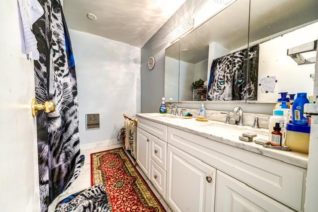 600 Naples Ct Unit 107, Glenview, IL 60025 - bathroom with double vanity and baseboards