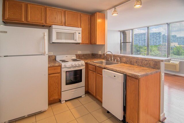 345 E Eastgate Pl Unit 505, Chicago, IL 60616 - kitchen with white appliances, a peninsula, brown cabinetry, light tile patterned floors, and rail lighting