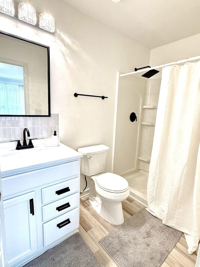 1567 Windward Dr, Pingree Grove, IL 60140 - bathroom with wood finished floors, toilet, backsplash, and vanity