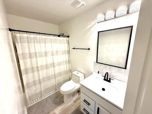 1567 Windward Dr, Pingree Grove, IL 60140 - bathroom featuring wood finished floors, toilet, vanity, decorative backsplash, and a shower with shower curtain
