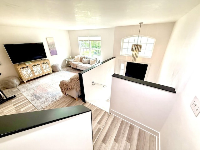 1567 Windward Dr, Pingree Grove, IL 60140 - living area featuring light wood-style flooring, a chandelier, and baseboards