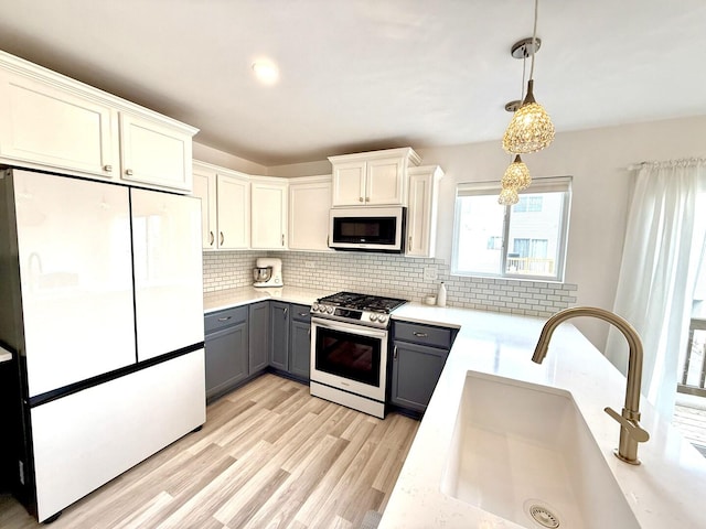 1567 Windward Dr, Pingree Grove, IL 60140 - kitchen with white appliances, gray cabinets, a sink, light countertops, and backsplash