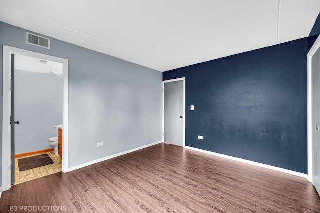 8124 168th Pl Unit 1E, Tinley Park, IL 60477 - spare room featuring wood finished floors and baseboards