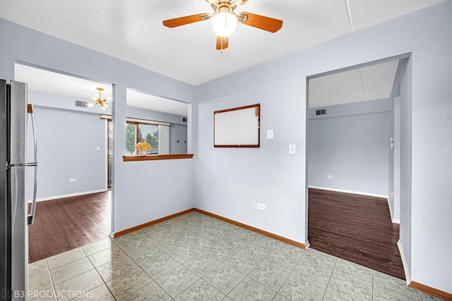 8124 168th Pl Unit 1E, Tinley Park, IL 60477 - unfurnished room featuring ceiling fan, baseboards, and light tile patterned floors