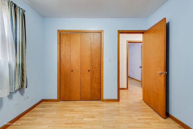 1903 Marshall Pkwy, Waukegan, IL 60085 - unfurnished bedroom with light wood-style floors and baseboards