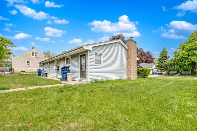 1903 Marshall Pkwy, Waukegan, IL 60085 - view of home's exterior with a yard and a chimney
