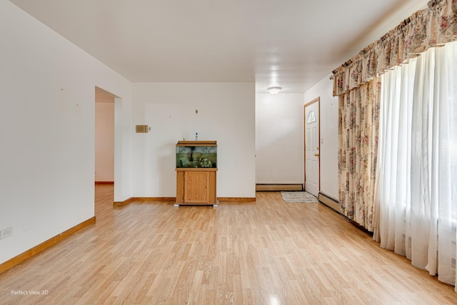 1903 Marshall Pkwy, Waukegan, IL 60085 - spare room with a baseboard radiator, light wood finished floors, and baseboards
