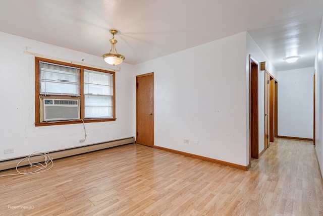 1903 Marshall Pkwy, Waukegan, IL 60085 - empty room featuring light wood finished floors, cooling unit, baseboards, and a baseboard heating unit